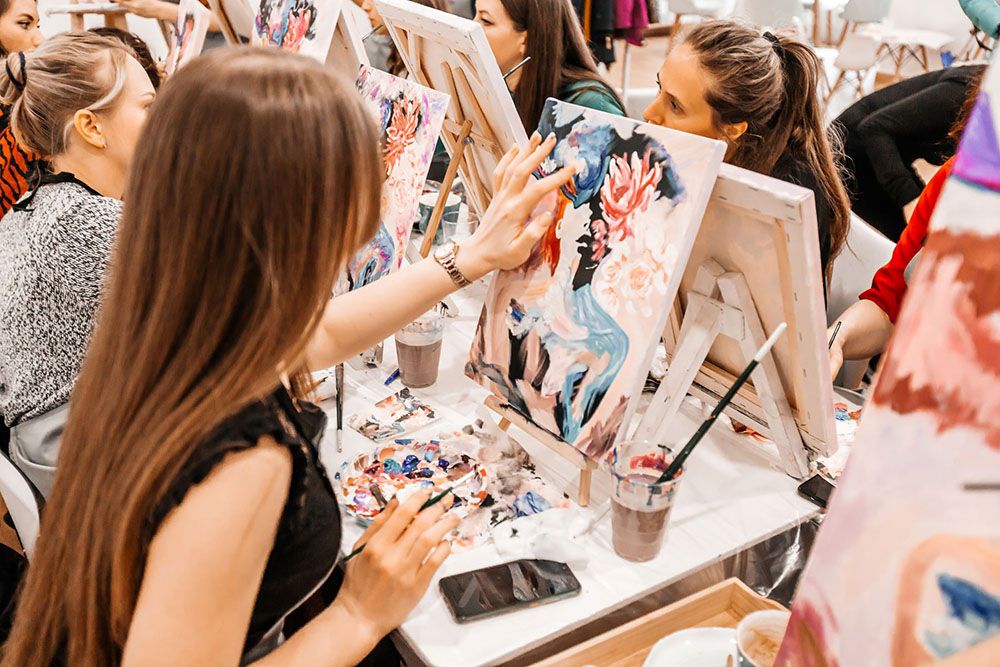 People painting in a painting class