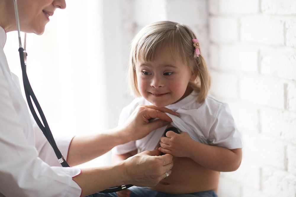 Doctor listens to child's heart